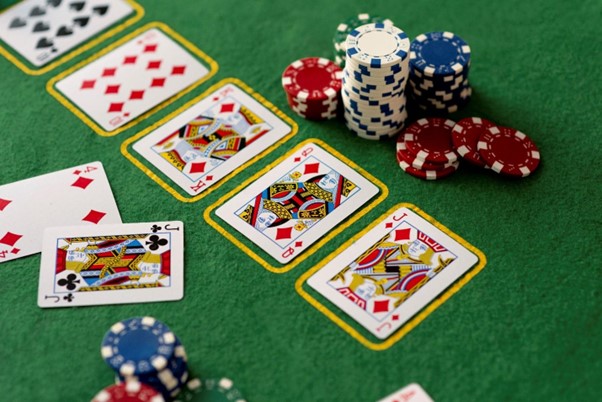 Poke playing cards on casino table next to casino chips
