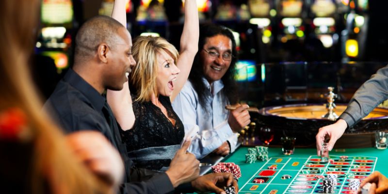 a lady celebrating her win at a roulette table