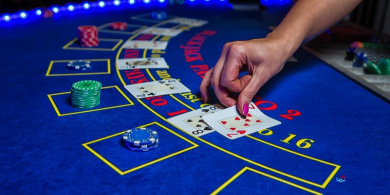 blackjack dealer placing cards down in a game of european blackjack
