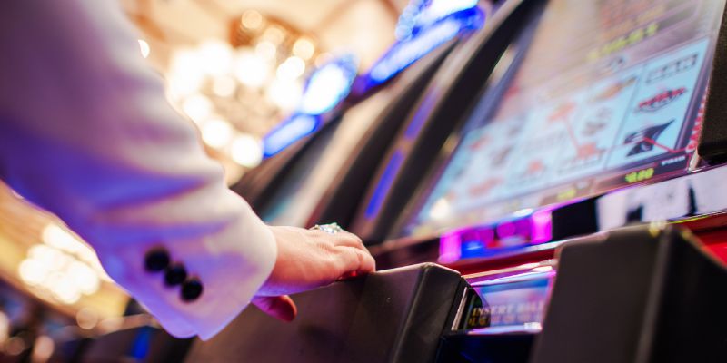 a man at playing at a slot machine a man at playing at a slot machine