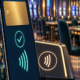 Editorial illustration of cashless casino payments, a secure mobile wallet, and a casino floor