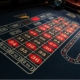 a roulette table with red and black pockets